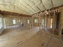 Open-concept living room featuring wood-frame construction, high ceilings, and window views at 2776 Rains Mill Rd, Princeton, NC 27569