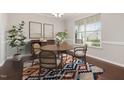 Bright dining room with a wood table, stylish chairs, and an area rug at 2855 Wilkes Lake Dr, Fuquay Varina, NC 27526
