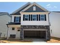 New construction two-story home featuring a two-car garage and stylish architectural details at 293 Gregory Village Dr, Lillington, NC 27546