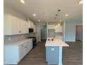 Spacious kitchen featuring stainless appliances, a large island, and plenty of storage at 293 Gregory Village Dr, Lillington, NC 27546
