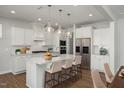 Bright kitchen features stainless appliances, white cabinetry, and large island at 293 Gregory Village Dr, Lillington, NC 27546
