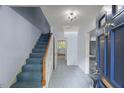 Bright entryway with staircase and tile flooring leading to various rooms in the home at 3025 Wycliff Rd, Raleigh, NC 27607