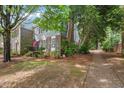 A lovely townhouse with a blend of brick and siding, surrounded by lush greenery at 3025 Wycliff Rd, Raleigh, NC 27607