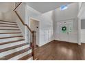 Bright foyer with hardwood floors, a staircase, and a view of the front door at 3108 Lawson Walk Way, Rolesville, NC 27571