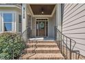 Inviting front entrance with brick steps, a wood door, and a decorative wreath for a warm welcome at 3108 Lawson Walk Way, Rolesville, NC 27571