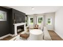 Cozy living room showcasing a fireplace, large windows, and comfortable seating at 323 Beacon Dr, Pittsboro, NC 27312