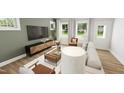 Comfortable living room featuring hardwood floors, bright windows, and stylish decor at 335 Beacon Dr, Pittsboro, NC 27312