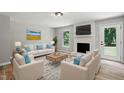 Bright living room with hardwood flooring, fireplace, neutral decor, and plenty of natural light at 3916 W Allen, Raleigh, NC 27603