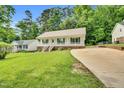 Well-kept single-story home featuring a front porch and a long driveway at 404 Southerby Dr, Garner, NC 27529