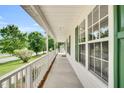 Extended front porch with white railing and green shutters on a charming home at 404 Southerby Dr, Garner, NC 27529