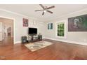 Bright living room with hardwood floors, a ceiling fan, and neutral wall colors at 411 E Green St, Franklinton, NC 27525