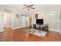 Open-concept living room featuring hardwood floors, a ceiling fan, and ample natural light at 411 E Green St, Franklinton, NC 27525