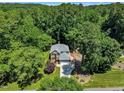 Stunning aerial view of a secluded home nestled among lush green trees offering privacy at 5121 Ten Point Trl, Wake Forest, NC 27587