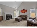 Cozy living room with a fireplace, neutral carpet, and a vaulted ceiling for a spacious feel at 5301 Northpines Dr, Raleigh, NC 27610