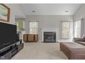 Bright living room featuring neutral walls, fireplace, and large windows that offer plenty of natural light at 5301 Northpines Dr, Raleigh, NC 27610
