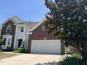 Lovely home with brick accents, a two-car garage, and well-maintained landscaping on a sunny day at 5708 Big Sandy Dr, Raleigh, NC 27616