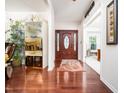 Inviting foyer with gleaming hardwood floors, a decorative rug, and an elegant wooden front door at 5708 Big Sandy Dr, Raleigh, NC 27616
