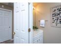 Cozy half bath with modern vanity, decorative mirror, and warm lighting at 7244 Galon Glen Rd, Raleigh, NC 27613