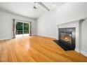Spacious living room with a fireplace, hardwood floors, vaulted ceilings and sliding door access to the outdoors at 8312 Bellingham Cir, Raleigh, NC 27615