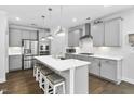 Modern kitchen with stainless steel appliances, a large center island, and stylish gray cabinetry at 1002 Gilly Ct, Durham, NC 27703