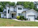 Charming two-story home featuring a two-car garage, complemented by well-manicured landscaping at 1003 E Sterlington Pl, Apex, NC 27502