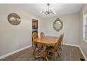 Cozy dining room featuring hardwood floors, stylish chandelier, and classic wooden table with matching chairs at 105 Tactical Dr, Bunnlevel, NC 28323