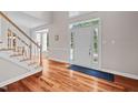 Bright foyer with hardwood floors, a staircase, and a front door with sidelights at 111 Gingergate Dr, Cary, NC 27519