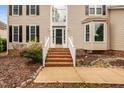 Inviting front entrance with brick steps leading to a classic black front door with sidelights at 111 Gingergate Dr, Cary, NC 27519