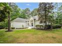 Beautiful white brick home featuring lush lawn and walkway to the front door at 12301 Hardee Rd, Raleigh, NC 27614