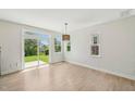 Open living space with light wood floors, large sliding doors to the patio, and ample natural light at 1534 Glenwater Dr, Cary, NC 27519