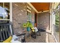 Inviting front porch with brick flooring, rocking chairs, and decorative accents at 154 Sicily Dr, Clayton, NC 27527