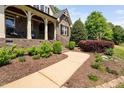 Beautifully landscaped front yard with a winding sidewalk leading to the front porch at 154 Sicily Dr, Clayton, NC 27527