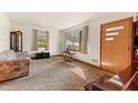 Spacious living room with natural light, carpeted floors, and classic furnishings at 1593 E Washington Ave, Creedmoor, NC 27522
