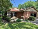 View of back of house with screened in porch and attached garage at 1818 Brookrun Rd, Henderson, NC 27536