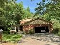 Attached garage and screened in porch add to the character of the brick home at 1818 Brookrun Rd, Henderson, NC 27536