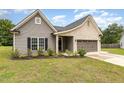 Charming single-story home with a mix of brick and vinyl siding, well-kept lawn, and an attached two-car garage at 1828 Wellspring Ct, Graham, NC 27253