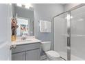 Well-lit bathroom with a clean vanity, modern fixtures, and a glass-enclosed shower, creating a refreshing space at 1928 Fishamble # 24, Fuquay Varina, NC 27526