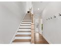 Elegant staircase with hardwood treads and white risers, leading to the upper level of this bright and modern home at 1928 Fishamble # 24, Fuquay Varina, NC 27526