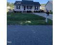 Quaint one-story home featuring a cozy front porch and a tidy front yard with a mailbox at 2001 Ballston Pl, Knightdale, NC 27545