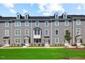 Attractive townhomes exhibit neat landscaping and welcoming doorways for an inviting curb appeal at 2006 Nola Ln, Durham, NC 27713