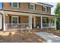 Inviting front porch with white railings and space for seating and decor at 2127 Somers Ave, Burlington, NC 27215