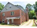 Rear view of the home showcasing brick architecture and an outdoor access road at 2210 Hope St, Raleigh, NC 27607