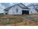 New construction home with Tyvek wrap, showcasing the initial phase of the building process at 223 Norman Ave, Lillington, NC 27546