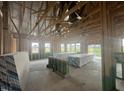 Unfinished interior showing the home's framing, windows, and lumber to give an idea of the size at 223 Norman Ave, Lillington, NC 27546