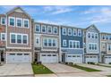 Stylish townhome row showcasing distinct color schemes and inviting curb appeal at 2299 Bay Minette Sta # 537, Apex, NC 27502