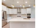 Modern kitchen featuring stainless steel appliances, white cabinets, and a center island at 2299 Bay Minette Sta # 537, Apex, NC 27502
