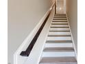 Clean and bright staircase features white risers and dark wood handrail at 2299 Bay Minette Sta # 537, Apex, NC 27502