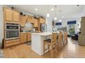 Spacious kitchen featuring an island with seating, stainless steel appliances, and plenty of counter space at 2410 Kinglass Dr, Fuquay Varina, NC 27526