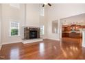 Spacious living room with hardwood floors, stone fireplace, and soaring ceilings creating an open atmosphere at 2507 Belvinwood Dr, Fuquay Varina, NC 27526