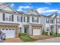 Attractive townhomes with stone accents, well-maintained landscaping, and private garages at 2513 Asher View Ct, Raleigh, NC 27606